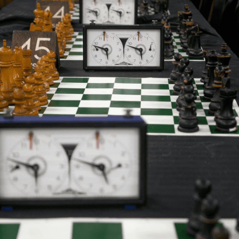Chess clocks and boards ready for multiple games.