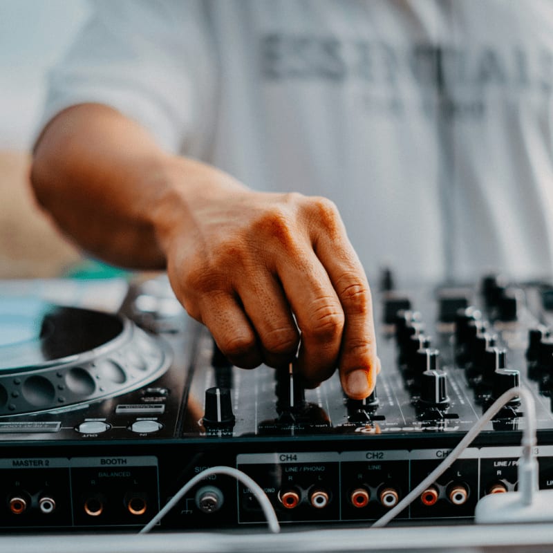 a dj mixing a track on a turntable