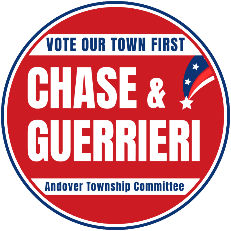 A circular campaign logo with "CHASE & GUERRIERI" prominently displayed in white text on a red background, featuring "VOTE OUR TOWN FIRST" at the top and "Andover Township Committee" at the bottom, with a small American flag motif in the upper right corner.