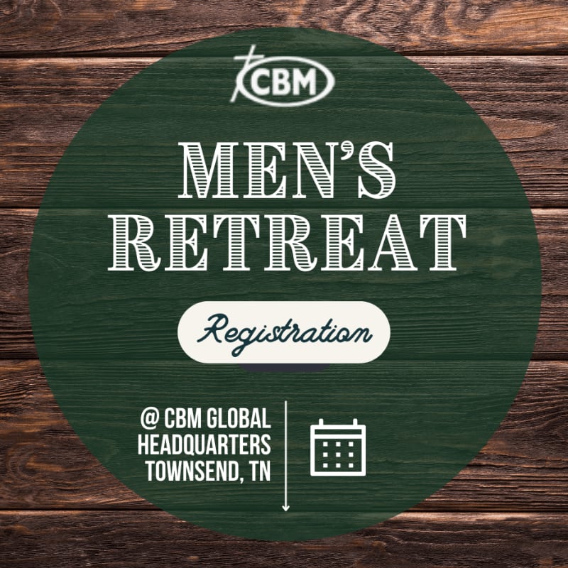 A dark green circular sign advertising a Men's Retreat is centered over a rustic brown wooden plank background.