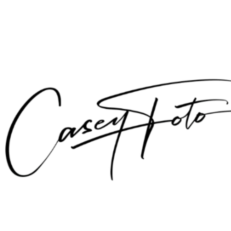 A black cursive signature reading "Casey Foto" is centered against a plain white background.