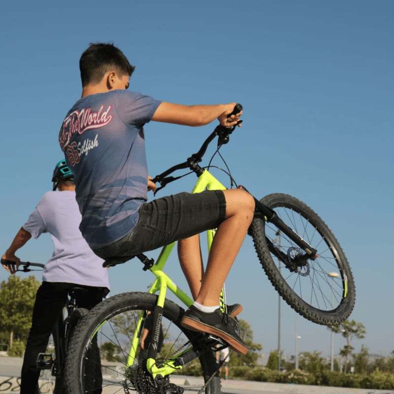 man in red and white crew neck t-shirt riding on black and yellow bmx bike
