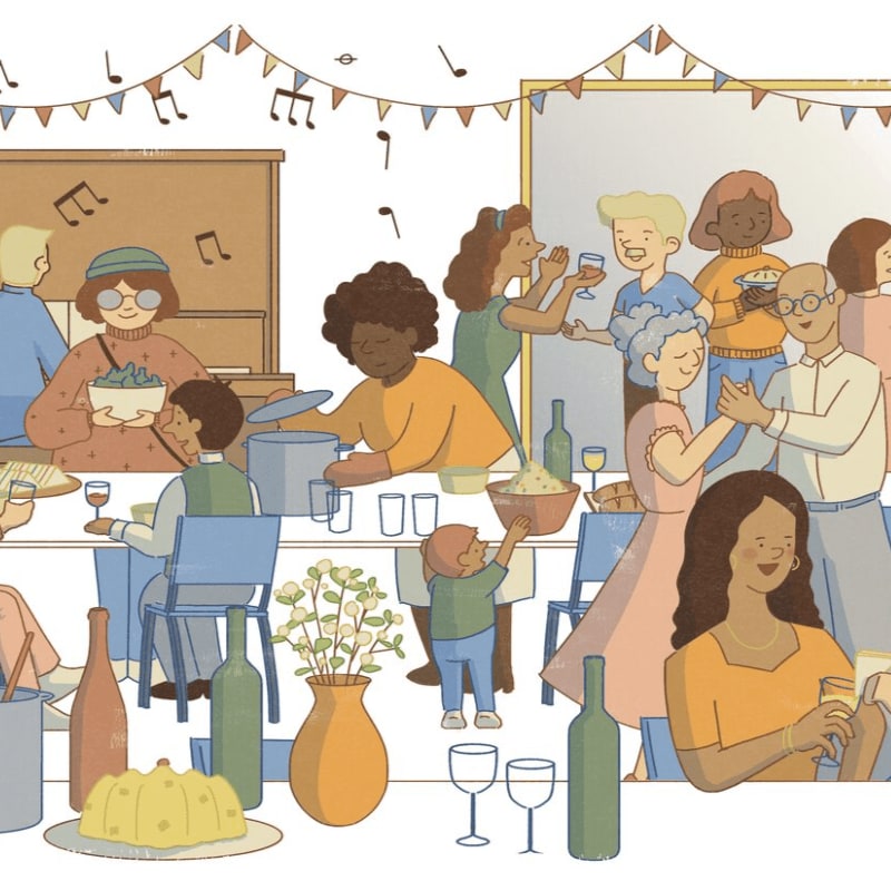 A diverse group of people gather for a party with food and drinks in the foreground and a festive room decorated with banners in the background.