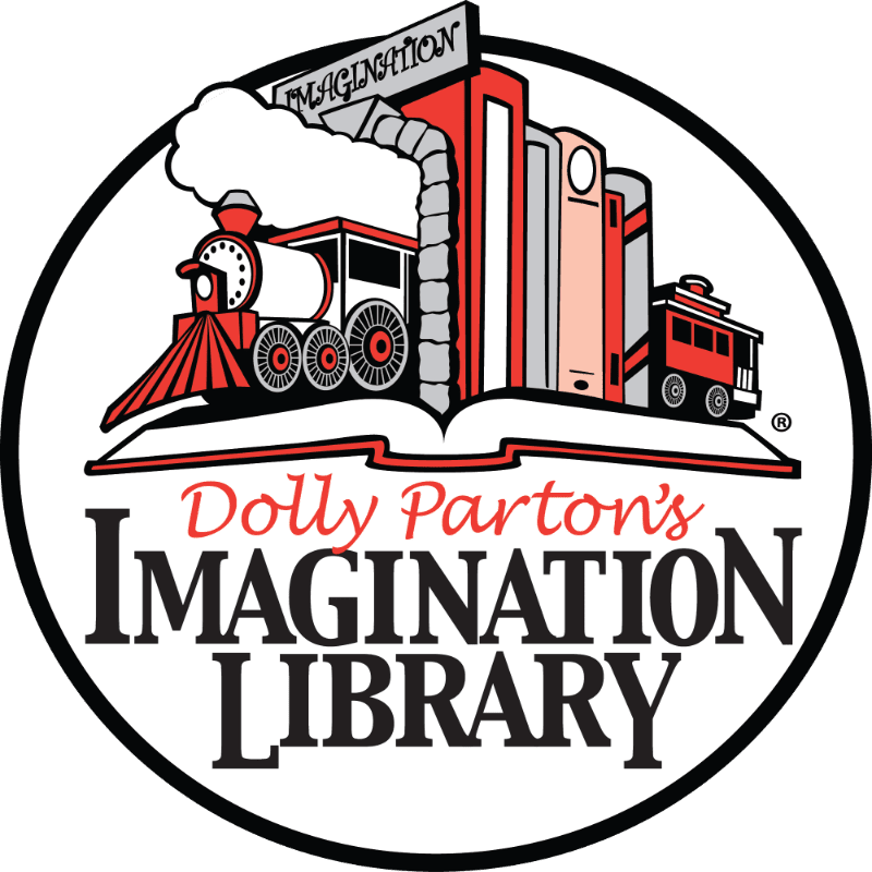 A red and black steam train emerges from an open book in the foreground, set against a background of stylized city buildings and a sign reading "IMAGINATION."