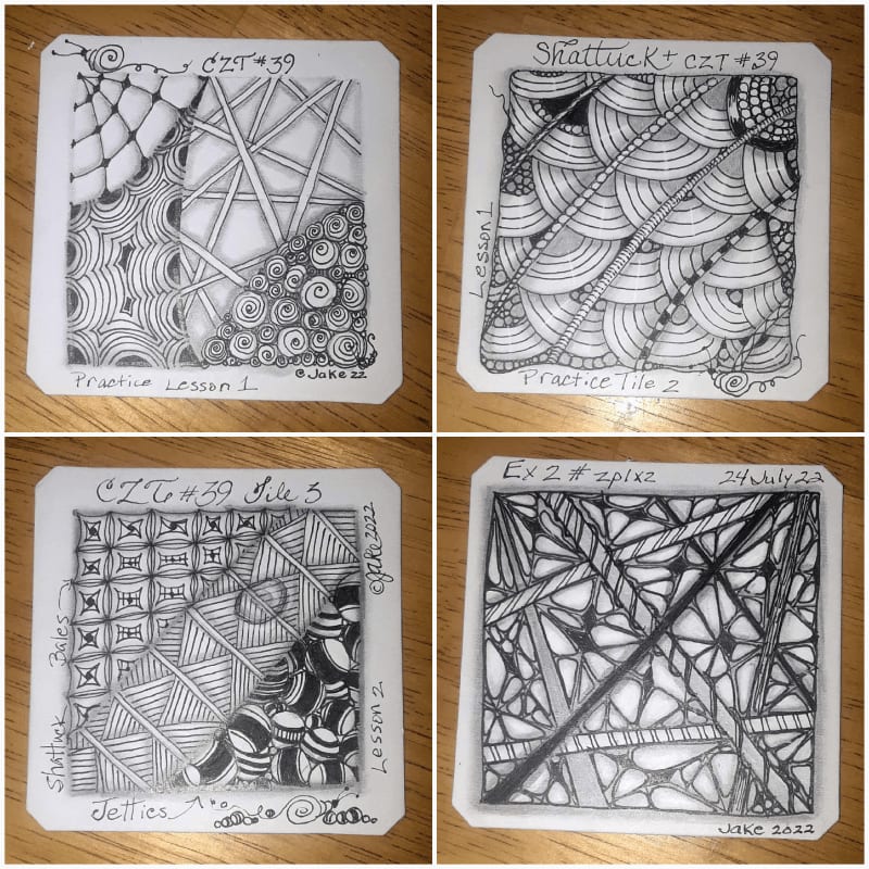 Four square pieces of paper featuring intricate black-and-white zentangle drawings are arranged in a grid on a light brown wooden surface.