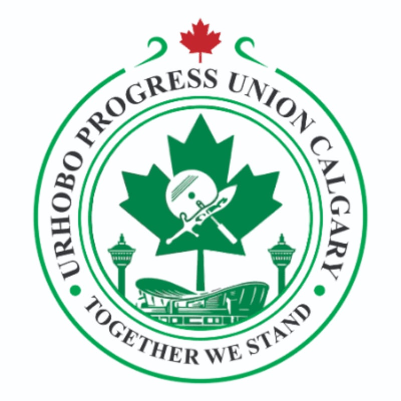 A green and white circular logo features a maple leaf with crossed swords and a shield in the foreground, set against a background of two towers and a stadium, all topped with a red maple leaf.