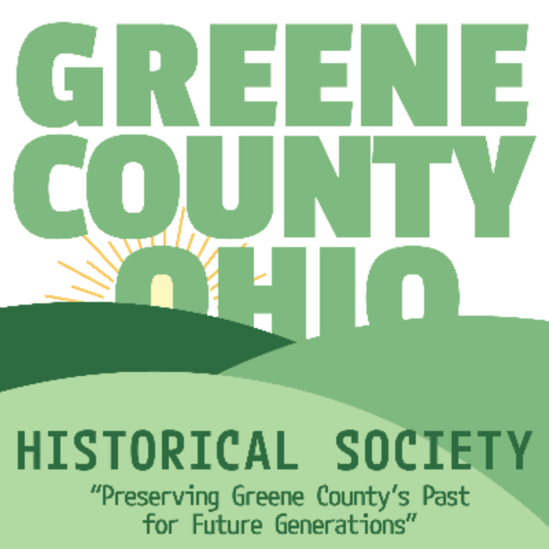 Green text on a white background reads "GREENE COUNTY OHIO" above rolling green hills and a rising sun, with "HISTORICAL SOCIETY" and a slogan below.