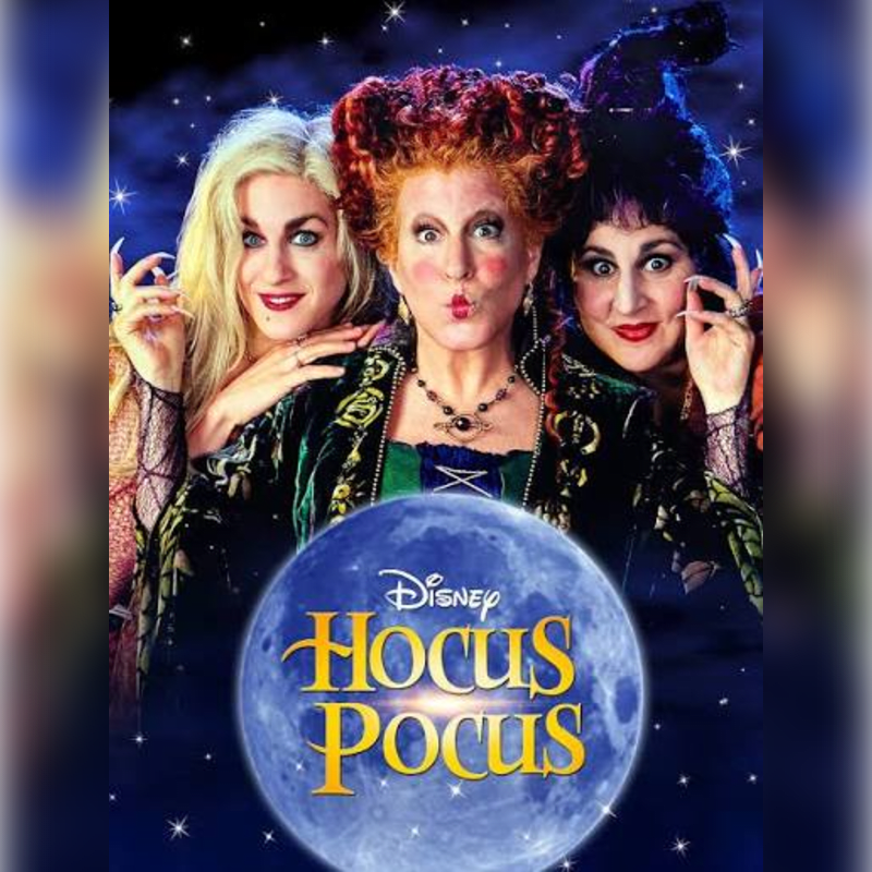 Three witches pose behind a glowing moon featuring the "Hocus Pocus" logo against a dark, starry night sky.