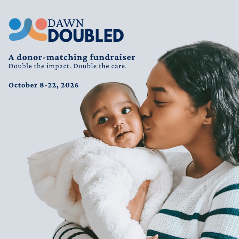 A woman kisses a baby's cheek in the foreground against a light gray background featuring text for a "Dawn Doubled" fundraiser.