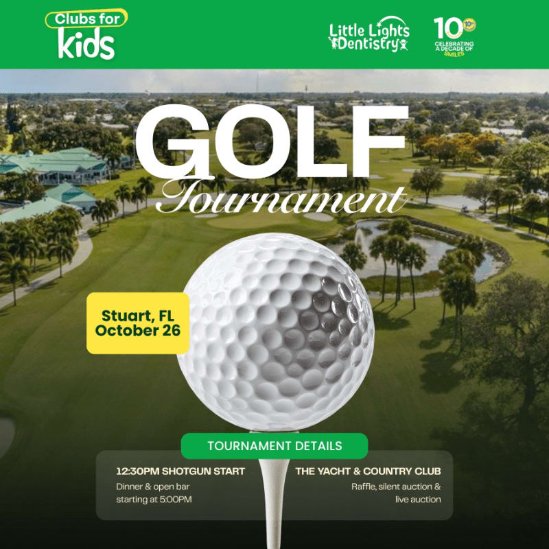 A large white golf ball on a tee sits in the foreground against a background of a lush green golf course and clubhouse.