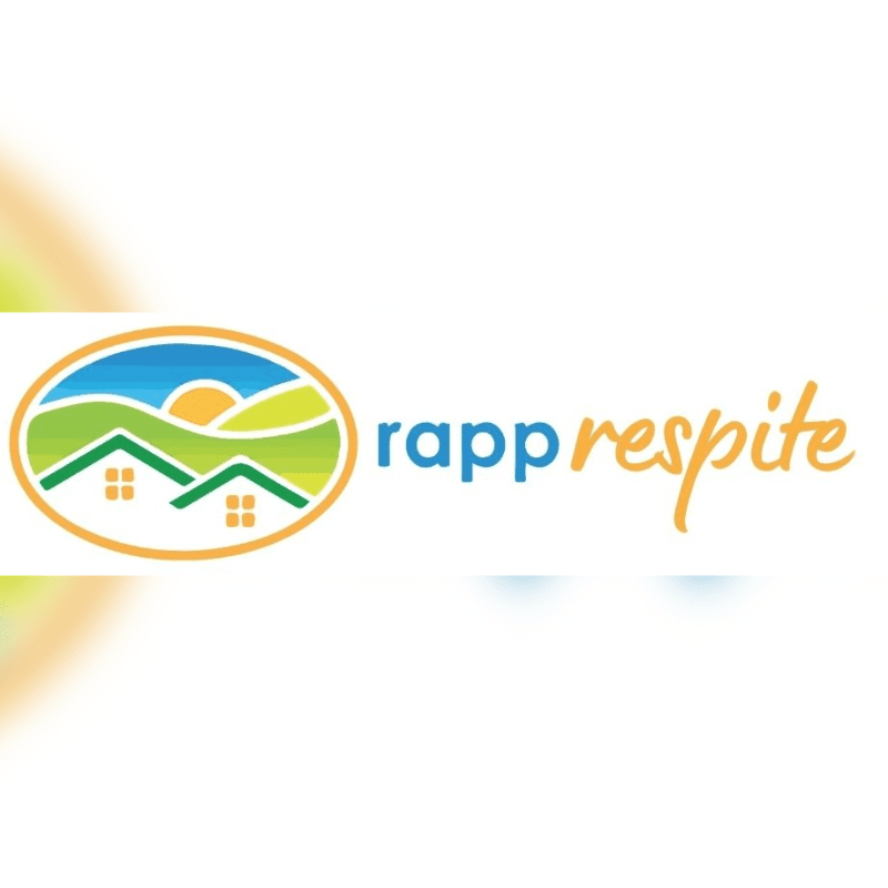 A logo featuring a colorful oval landscape with houses in the foreground and a sun over green hills in the background, set against a plain white backdrop.