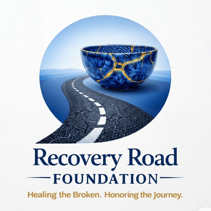 A blue kintsugi bowl sits atop a cracked road that winds toward a distant blue horizon within a circular frame.