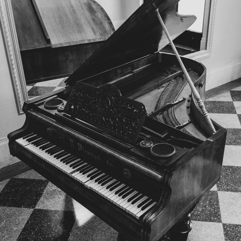 greyscale photo of grand piano