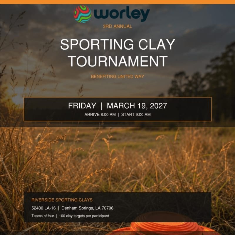 Text announcing a sporting clay tournament is overlaid on a landscape of golden grass in the foreground and a soft, sunset sky with distant trees in the background.