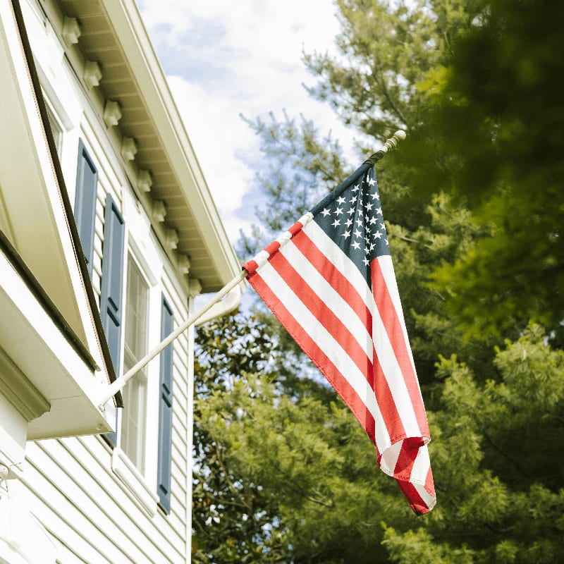 American flag proudly displayed on a white house