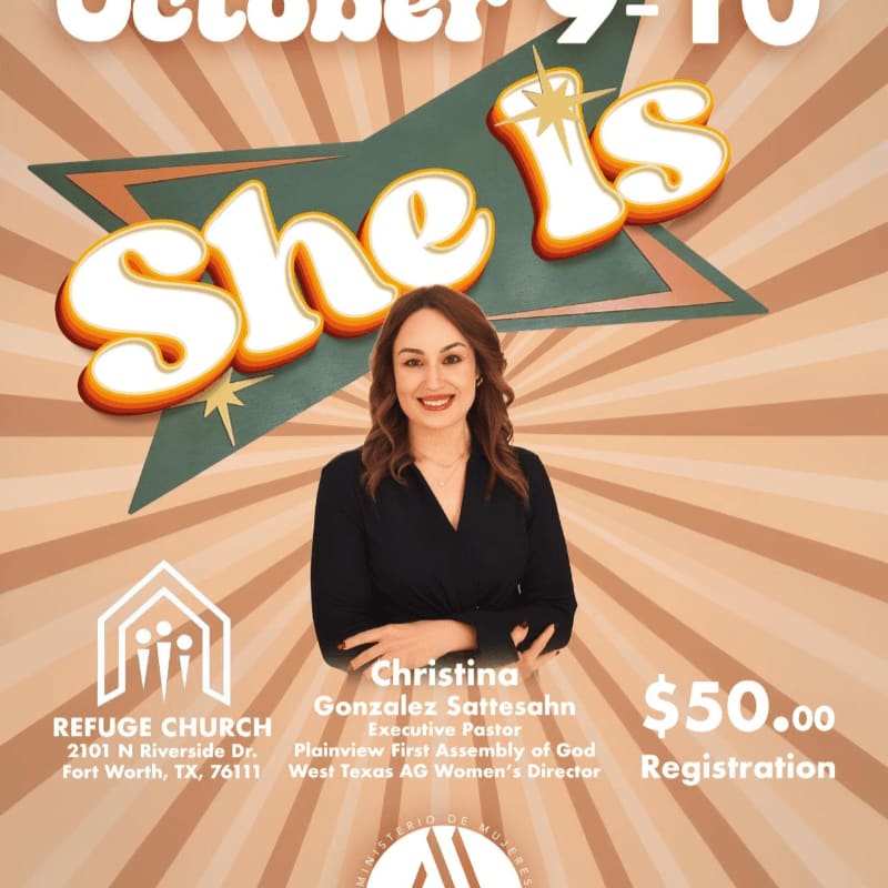 A smiling woman in a black dress stands in the foreground against a tan sunburst background featuring the stylized text "She Is."