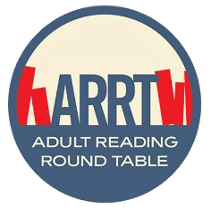 A circular logo with a cream-colored center features the red and blue letters "KARRTV" above the text "ADULT READING ROUND TABLE" on a dark blue background.