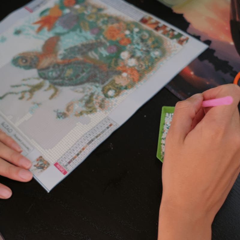 Person creating a diamond painting of a sea turtle