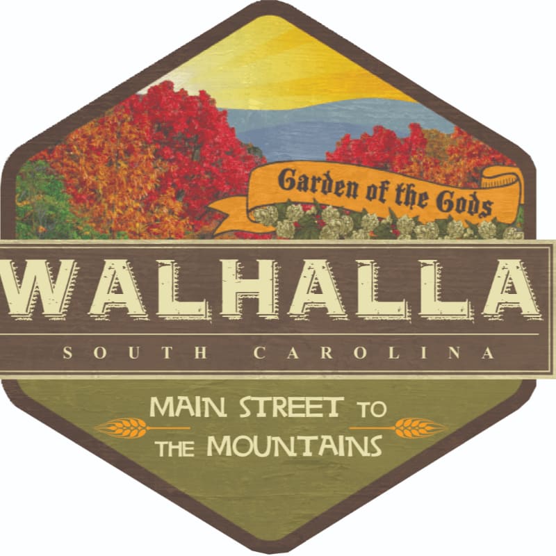 A hexagonal sign features the text "WALHALLA SOUTH CAROLINA" in the foreground, with a background of red autumn foliage, blue mountains, and a banner reading "Garden of the Gods."