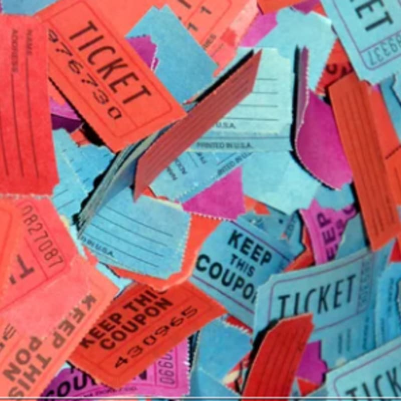 A scattered pile of red, blue, and purple ticket stubs and coupons fills the entire frame.