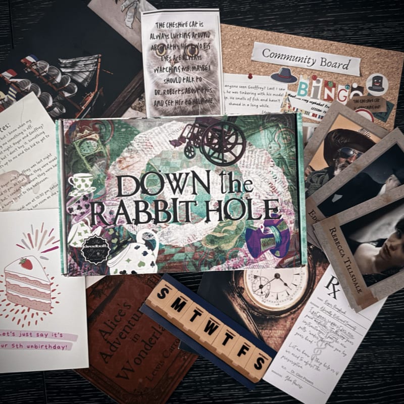 A "Down the Rabbit Hole" game box sits in the foreground, surrounded by a background of scattered clues, letters, photographs, and a book.