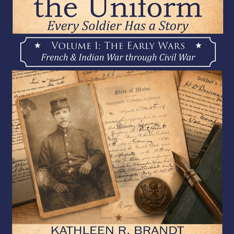 A vintage photograph of a soldier and a military button sit atop aged documents and a leather book.