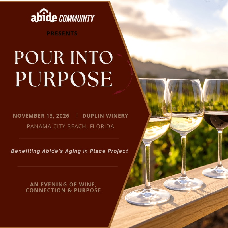An event flyer with maroon text on the left overlays a foreground of three wine glasses on a wooden ledge against a background of a sunlit vineyard.
