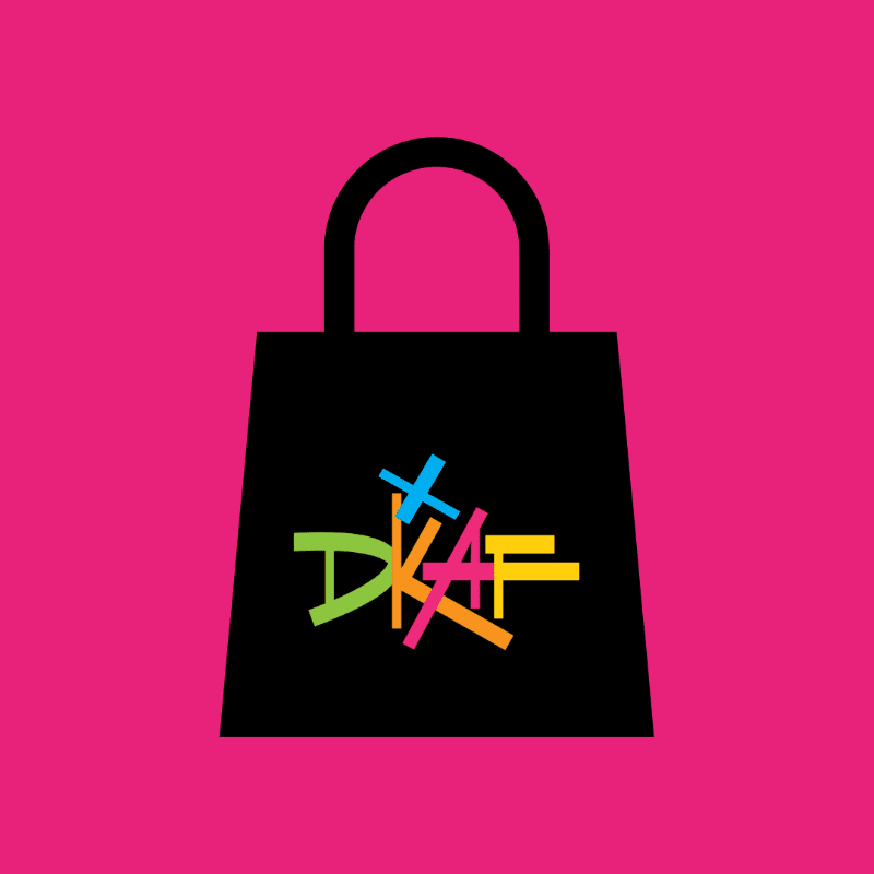 A black shopping bag with colorful letters on it is centered against a bright pink background.