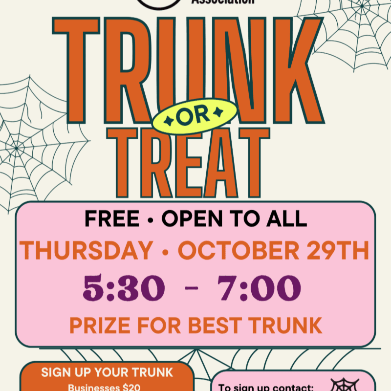 Bold orange "TRUNK OR TREAT" text and event details are centered in the foreground against a light beige background decorated with spider webs.