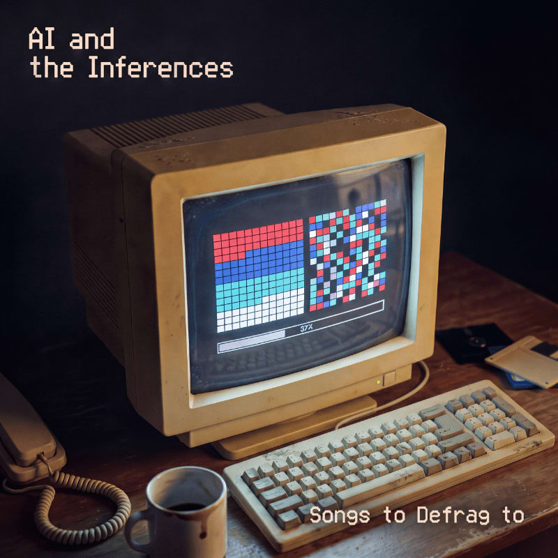 An old, beige computer with a colorful pixelated screen and a keyboard sits on a wooden desk next to a coffee mug and telephone against a dark background.