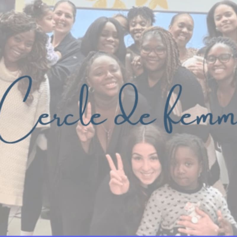 A group of women and children pose for a photo in front of a banner that reads "Cercle de femmes."