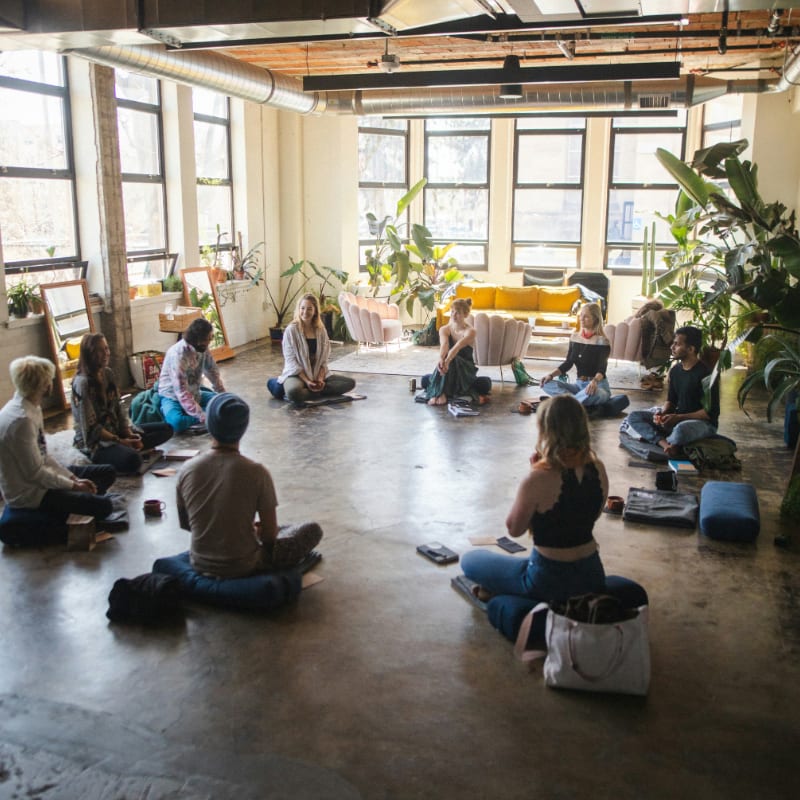 a group of people sitting in a circle in a room