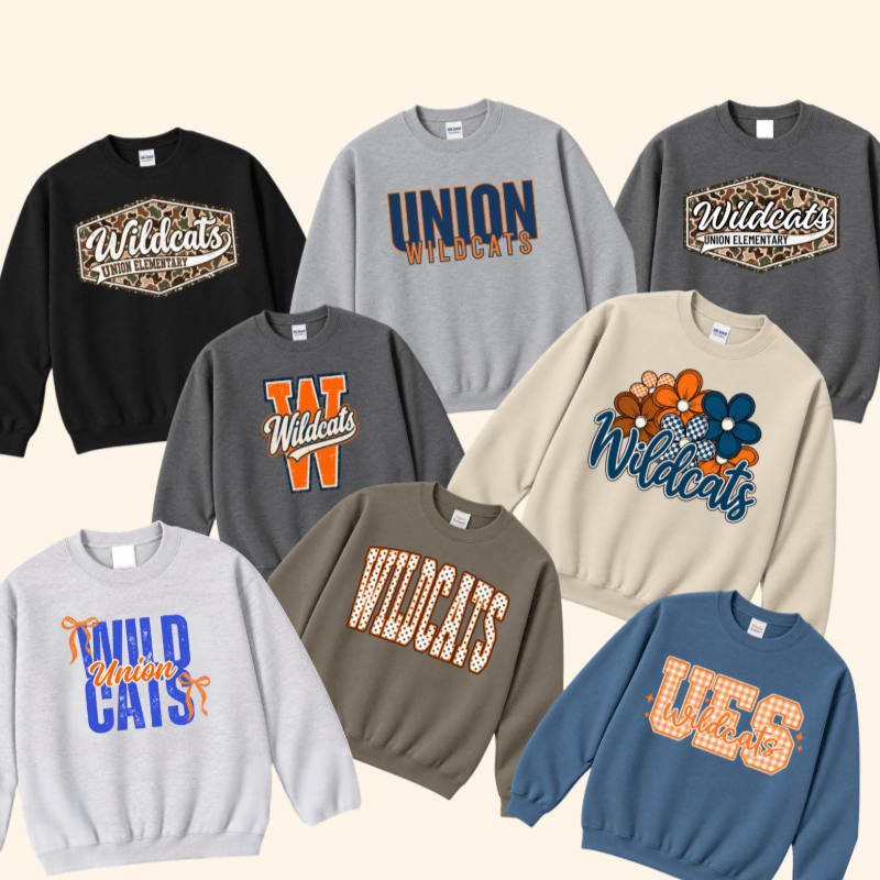 Various colorful sweatshirts with "Wildcats" and "Union" graphics are arranged against a plain, light beige background.