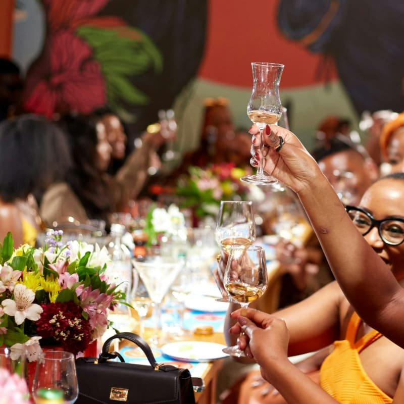 A group of people sitting at a table with wine glasses