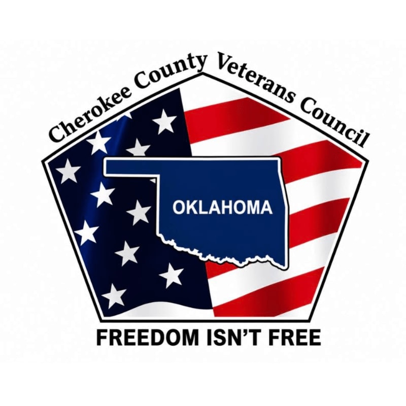 A blue silhouette of Oklahoma with the text "OKLAHOMA" sits atop a stylized American flag background, all enclosed in a shield with "Cherokee County Veterans Council" above and "FREEDOM ISN'T FREE" below.