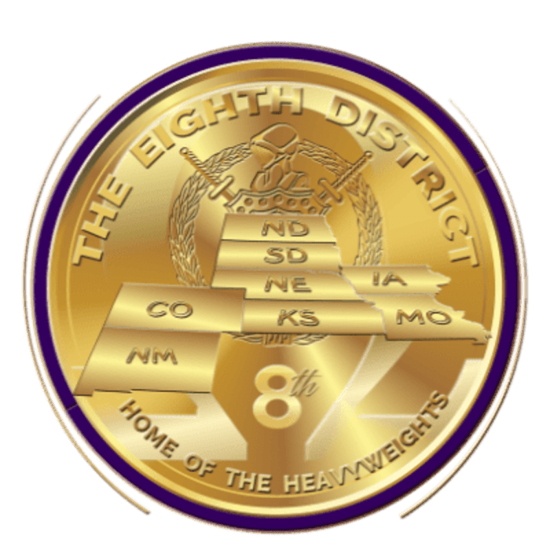 A gold coin with a purple border features a map of several US states in the foreground and a laurel wreath with a soldier's helmet in the background.