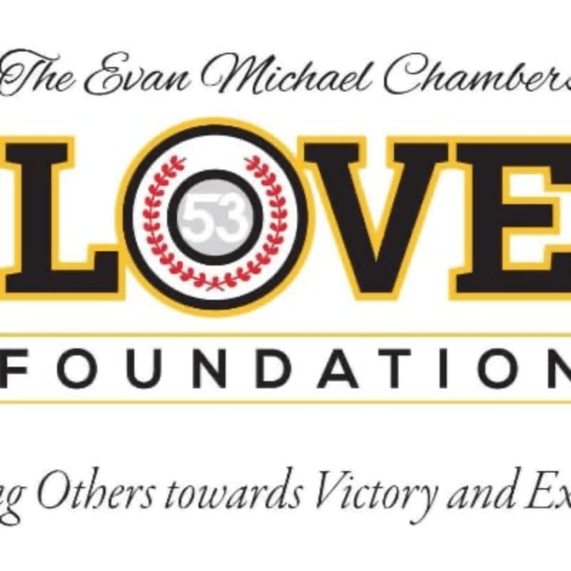 The foreground displays bold yellow and black lettering spelling out "LOVE FOUNDATION" with a baseball-themed circle in place of the "O", while the background features elegant script text reading "The Evan Michael Chambers" above and a motivational quote below.