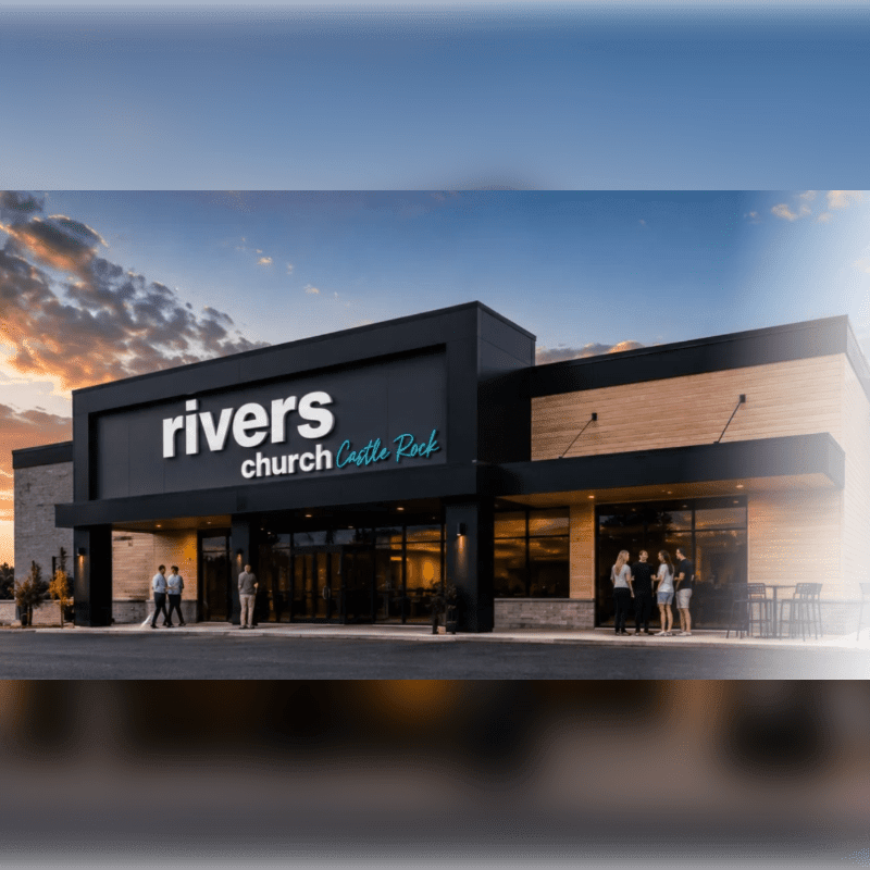 People stand in front of a modern Rivers Church building under a dramatic sunset sky.