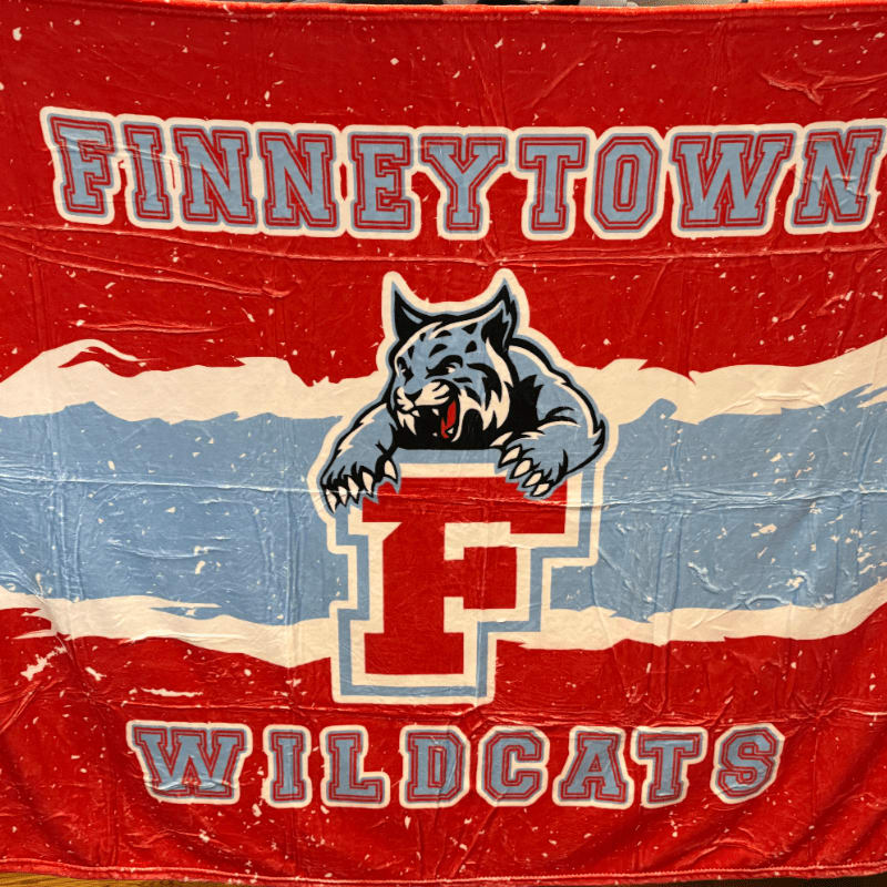 A blue wildcat mascot and a large letter "F" are centered on a red and blue banner with the words "FINNEYTOWN WILDCATS."