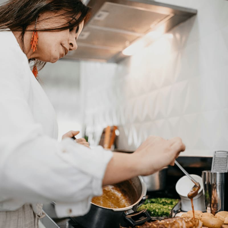 woman in white long sleeve shirt holding silver fork