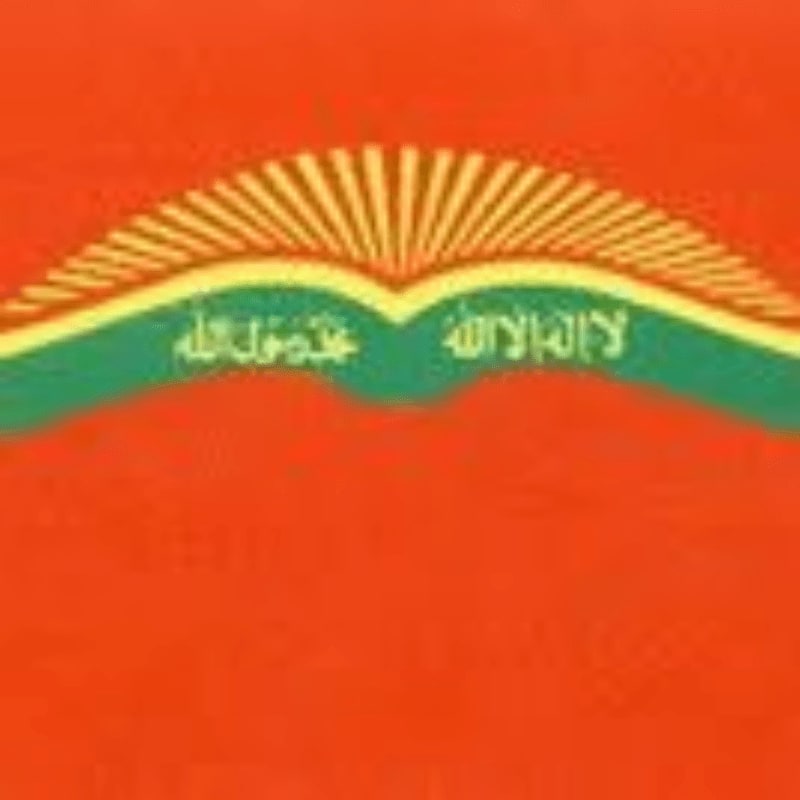An open green book with Arabic calligraphy and a yellow sunburst sits against a solid orange background.