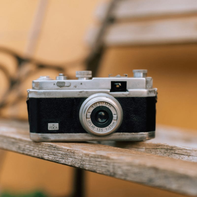 Vintage camera rests on a wooden bench
