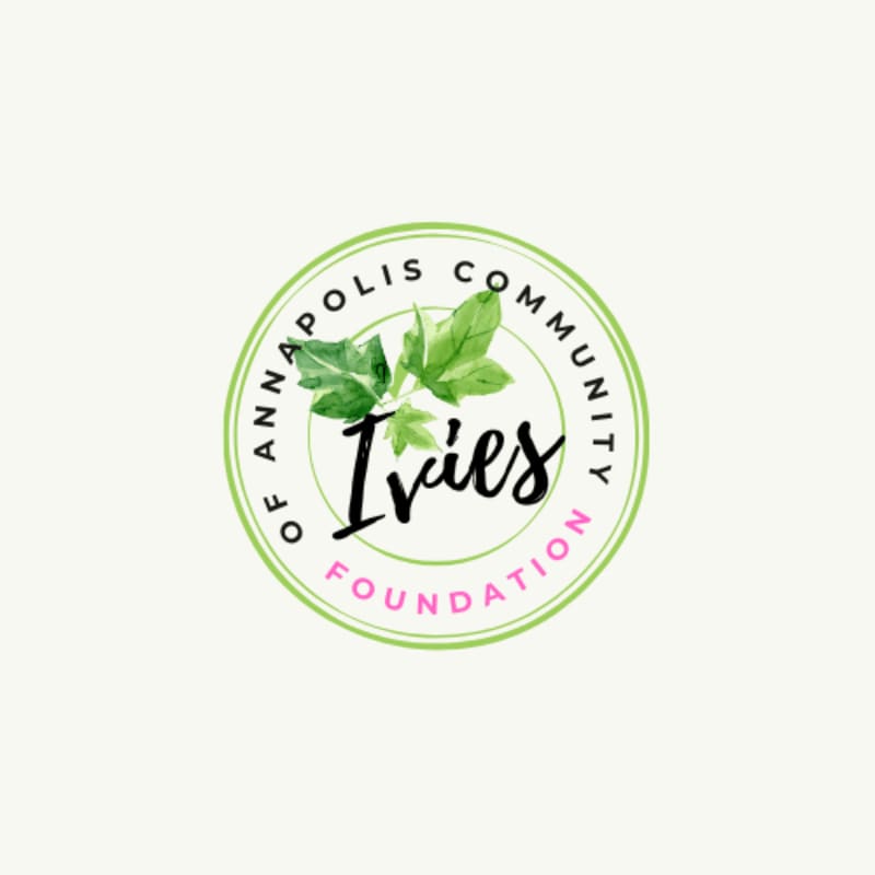 A circular logo featuring green leaves and the text "Ivies" in black and "Annapolis Community Foundation" in green and pink, set against a plain off-white background.