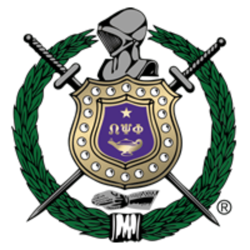 A gold shield featuring a purple emblem is centered before two crossed swords and a knight's helmet, all enclosed within a green laurel wreath.