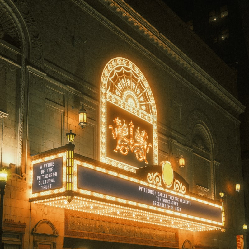 Ornate theater marquee illuminated at night