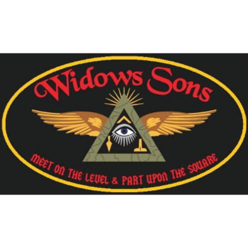 A winged pyramid with an all-seeing eye and Masonic text is centered within a yellow oval against a black background.