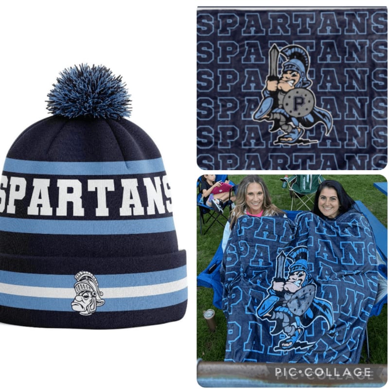 A blue and white "Spartans" knit beanie is positioned on the left, while the right side features a matching themed blanket and two women wrapped in it against an outdoor background.