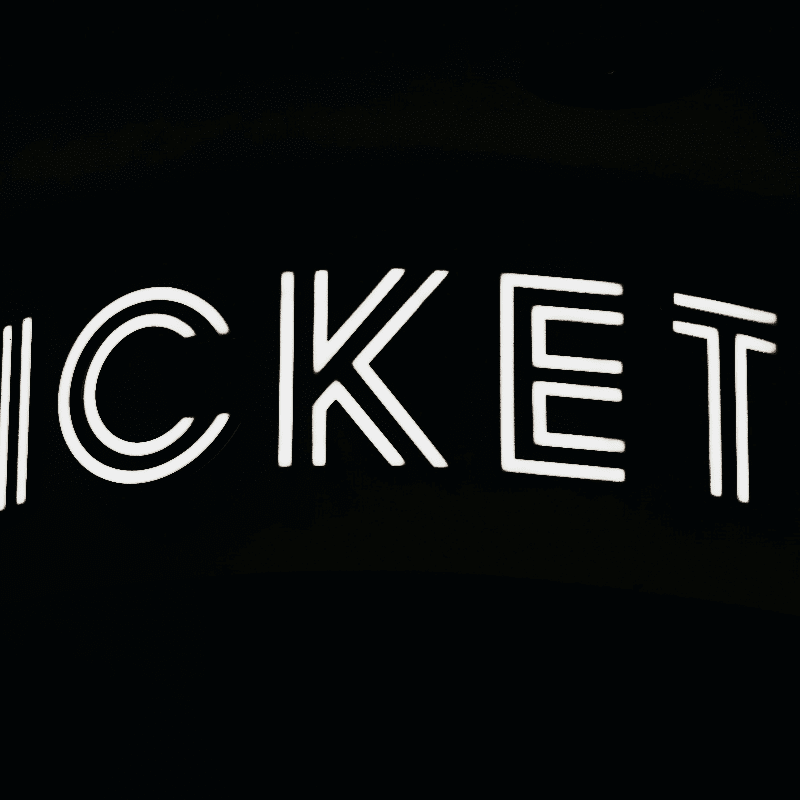 a black and white photo of a neon sign