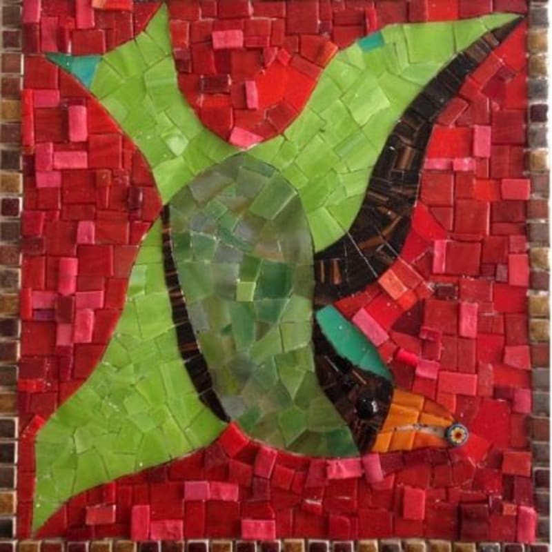 A vibrant green mosaic bird with outstretched wings flies against a background of red and brown tesserae, bordered by a mosaic frame.