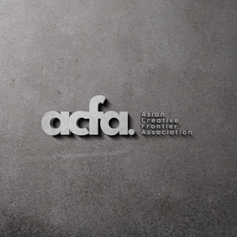 The text "acfa. Asian Creative Frontier Association" is embossed in white against a textured gray concrete background.